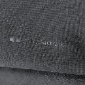 A textured black fabric with a subtle logo or branding visible.
