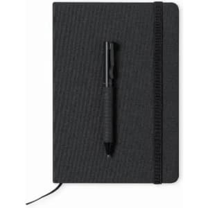A black notebook with a textured cover and a matching black pen resting on it. It features an elastic closure and bookmark.