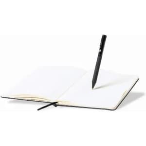 An open notebook with blank pages and a black pen resting vertically on the right page.