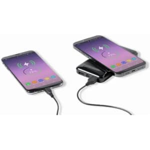 A charging pad with two smartphones connected via cables, featuring a sleek design in black.