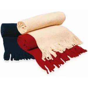A set of three rolled blankets in navy blue, cream, and red, featuring fringed edges. There is branding visible.