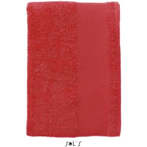 A heavy weight 500gsm cotton hand towel in a vibrant coral colour, featuring a simple design and brand logo.