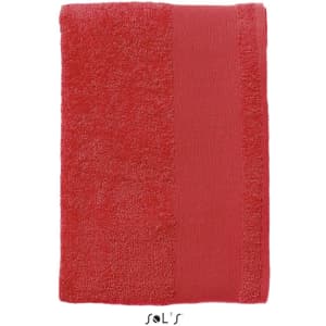 A red bath towel measuring 140cm x 70cm, heavy weight 500gsm cotton, featuring a logo.