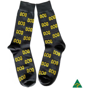 A pair of dark grey socks featuring a repeating yellow logo pattern. The socks include a branding logo.