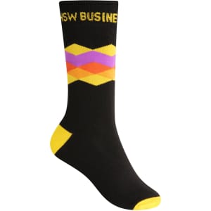 A pair of black socks featuring a colourful geometric pattern with yellow, pink, and orange accents and a logo.