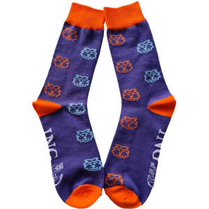 A pair of purple socks with orange cuffs and playful blue and orange lion motifs, featuring a logo.