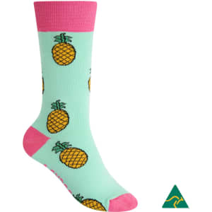 A pair of mint green socks featuring pineapple designs and a pink cuff, with a logo present.