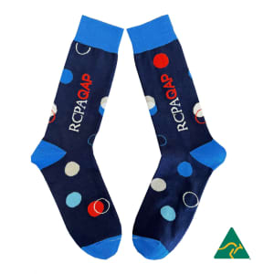 A pair of navy blue socks featuring multicoloured polka dots and a logo, with blue cuffs.