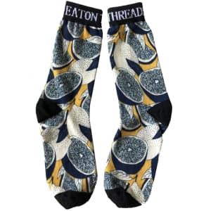 A pair of 3D printed dress socks featuring a vibrant citrus pattern in yellow, navy, and black.