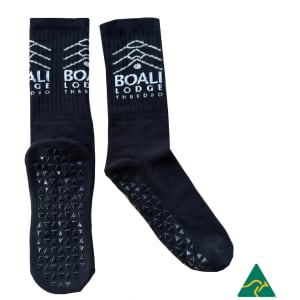 Crew Grip socks in black with textured soles and a logo on the upper side.