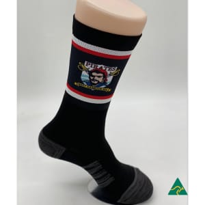 A black sock featuring a graphic design and contrasting red and grey stripes, displayed on a mannequin foot.