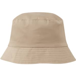 A reversible bucket hat in a neutral beige colour with a subtle textured finish and a branding logo.