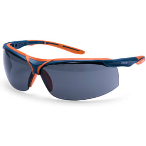 A pair of safety glasses featuring a dark lens with navy and orange frames and a logo on the side.