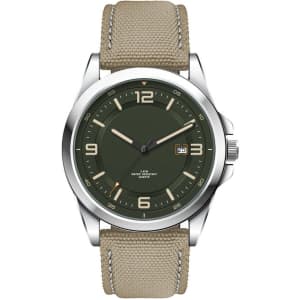 A casual unisex watch featuring a green dial, silver case, and a beige rPET strap, with a logo on the dial.