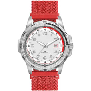 A sports watch with a silver face and a bright red nylon strap, featuring a logo on the side.
