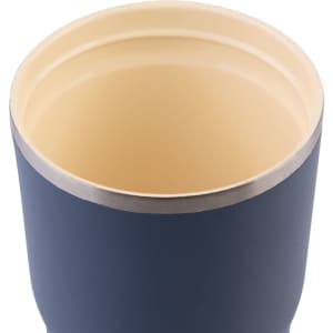 A drink bottle featuring a navy exterior and a cream interior, with a stainless steel rim and a logo.