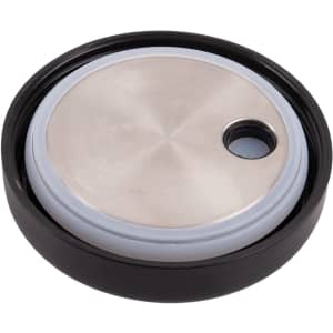 A black vacuum food pod lid with a stainless steel top and a circular shape. It features a small opening.