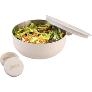 A bowl in cream colour with a salad inside, accompanied by a small container, featuring a logo.