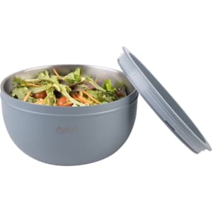 A salad bowl in light blue with a double wall design, featuring a lid and filled with mixed salad ingredients.