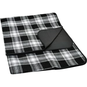 A black and white checked picnic rug with a smooth backing, featuring an integrated fold for easy storage.