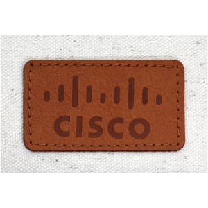 A tan leather label with a logo and the word "CISCO" embossed on a textured cream background.