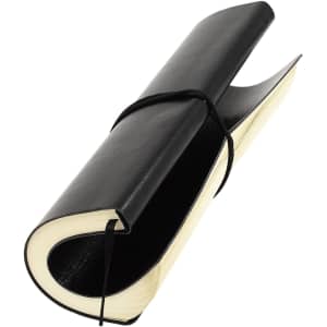 A black Tango Plus A5 notepad with a curved design, featuring elastic closure and blank pages.