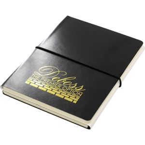A black A5 notebook with a gold logo, featuring a soft cover and an elastic band closure.