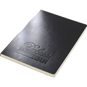 A black A5 notebook with a textured cover and an embossed logo. It features cream-coloured pages.