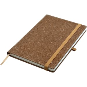 A brown bonded leather A5 notebook with an elastic closure and a ribbon marker, featuring a logo on the cover.