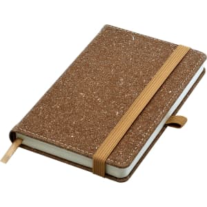 A brown bonded leather A6 notebook with an elastic band and a ribbon bookmark. It has a textured surface.
