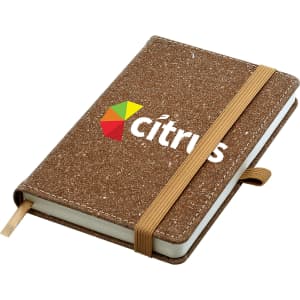 A bonded leather notebook with a textured brown cover and an elastic band, featuring a logo on the front.