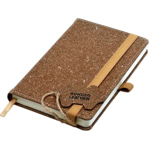 A brown bonded leather notebook with an elastic band and ribbon bookmark, featuring a textured cover and a logo.