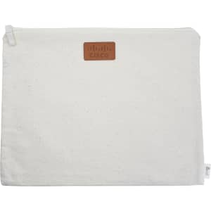 A cream-coloured conference bag with a leather logo patch, featuring a zip closure and a simple design.