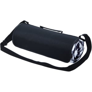 A large picnic rug rolled up in a black carry bag with a shoulder strap and a patterned inner design.