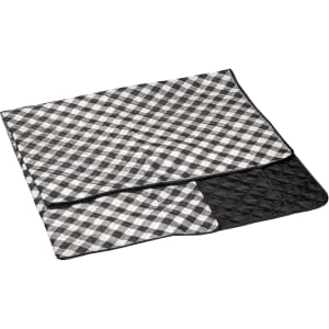 A large picnic rug featuring a black and white checkered pattern with a black quilted section. It has a logo.