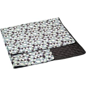 A large picnic rug featuring a geometric pattern in shades of green, blue, and black, with a quilted black underside.