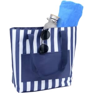 A navy and white striped tote bag with a drink bottle, a blue towel, and sunglasses inside.