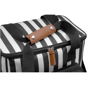 A cooler bag with black and white stripes featuring a brown leather handle, ideal for transporting drinks.
