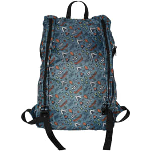 A fold-up backpack in blue with a vibrant pattern featuring various shapes and floral designs. It has black straps and a logo.
