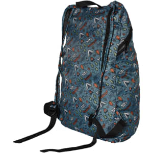 A fold-up backpack in blue with a playful pattern featuring various shapes and designs. It has shoulder straps and a small logo.