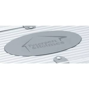 A silver metal plate with the brand name engraved, featuring a simple logo on a textured surface.