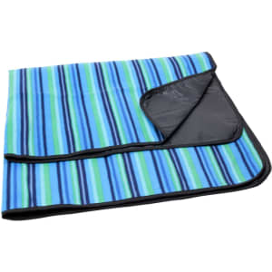 A striped picnic rug in blue, green, and black, featuring a black backing and a folded corner.