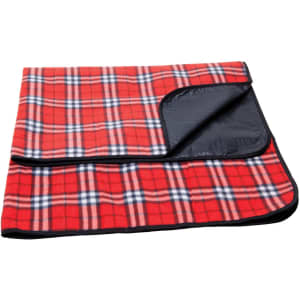A red check picnic rug with a black underside and a folded corner, featuring a plaid pattern.