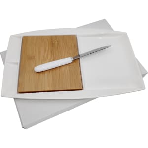A white Jumbo Party Plate with a bamboo cutting board and a metal knife, set against a plain background.