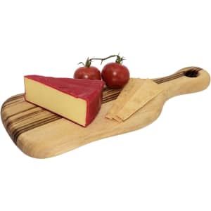 A small wooden serving board with a wedge of cheese, two tomatoes, and crackers. The board features a natural wood grain.