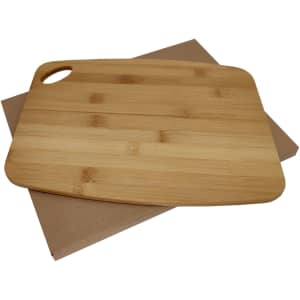 A bamboo cheese board with a smooth, natural finish resting on a cardboard base.