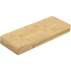 A bamboo cheese board with a smooth finish and a sliding compartment. It features a natural wood colour.