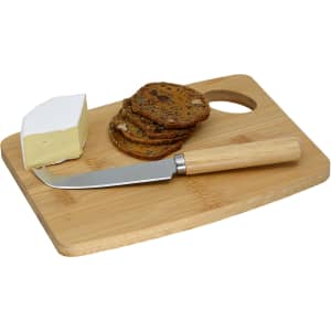 A bamboo cheese board featuring a cheese wedge, crispbread, and a cheese knife with a wooden handle.