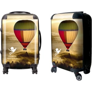 A wheeled suitcase features a colourful hot air balloon design and includes a logo. The suitcase is predominantly yellow and red.