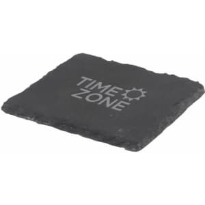 A slate coaster in a square shape featuring a logo, with a textured dark grey surface.
